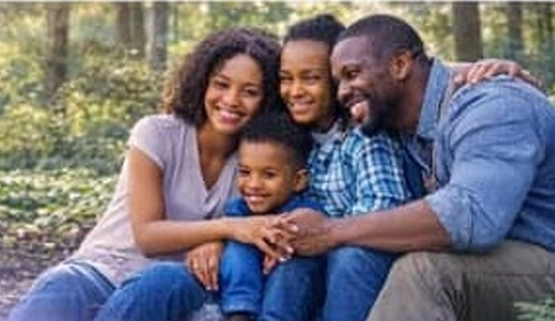 Family embracing outdoors in nature
